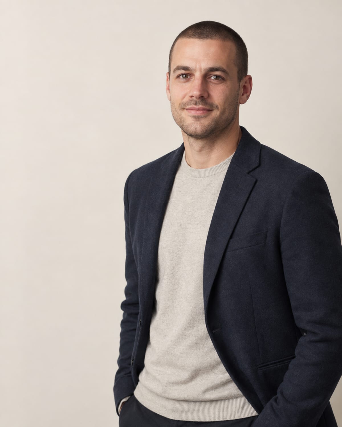 AI-generated layout placeholder portrait of a man with close-cropped hair; replace before launch.